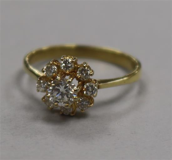 A modern 18ct gold and diamond cluster flower head ring, size O.